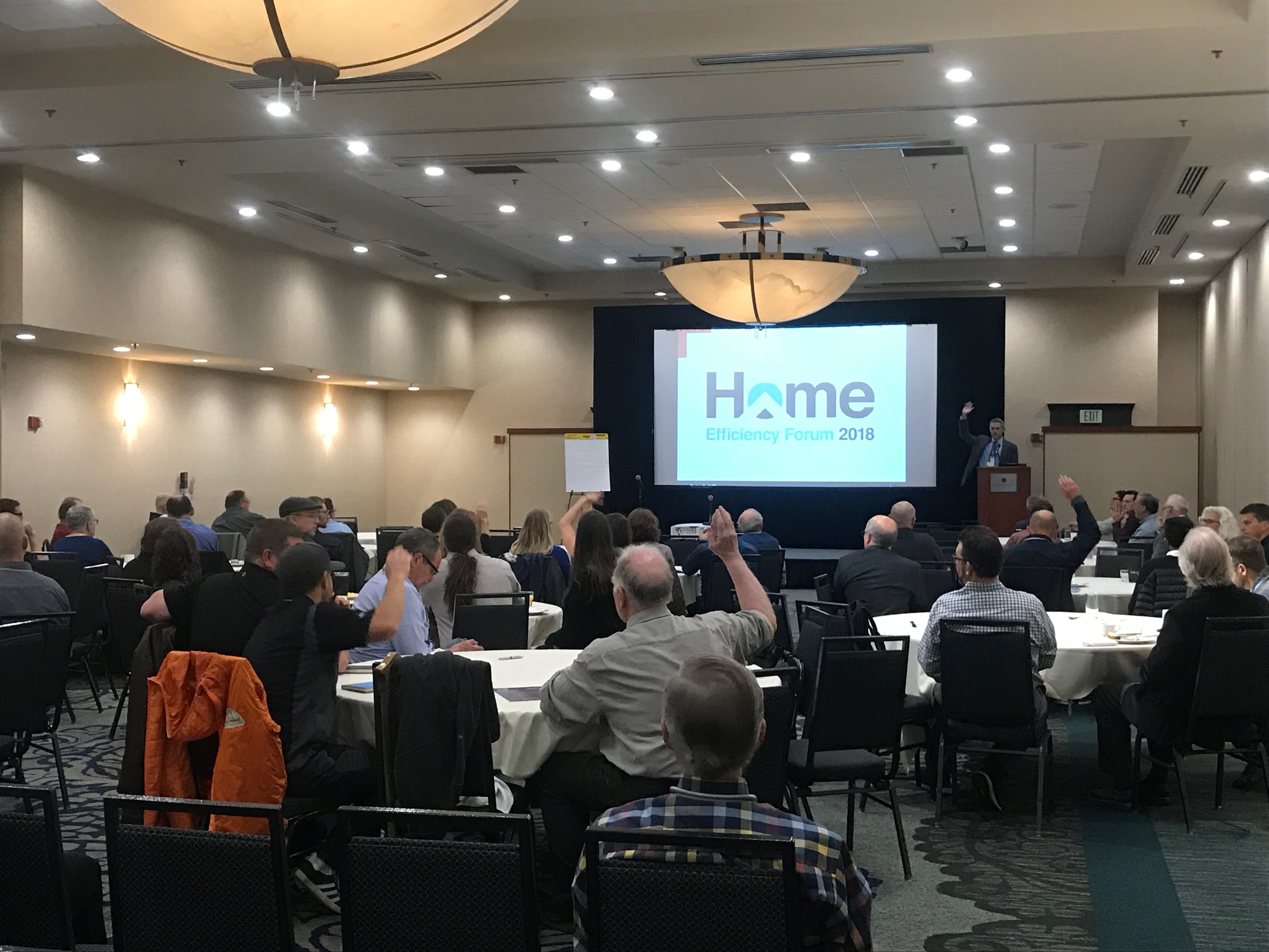 People viewing presentation in conference space for HEF 2018.